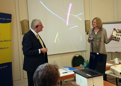 Mr. Tomas Pfeiffer, director of the professional chamber Sanator, and Ms. Nora Laubstein, president of ANME, with a picture of the Biotronic Centre for Social Support.